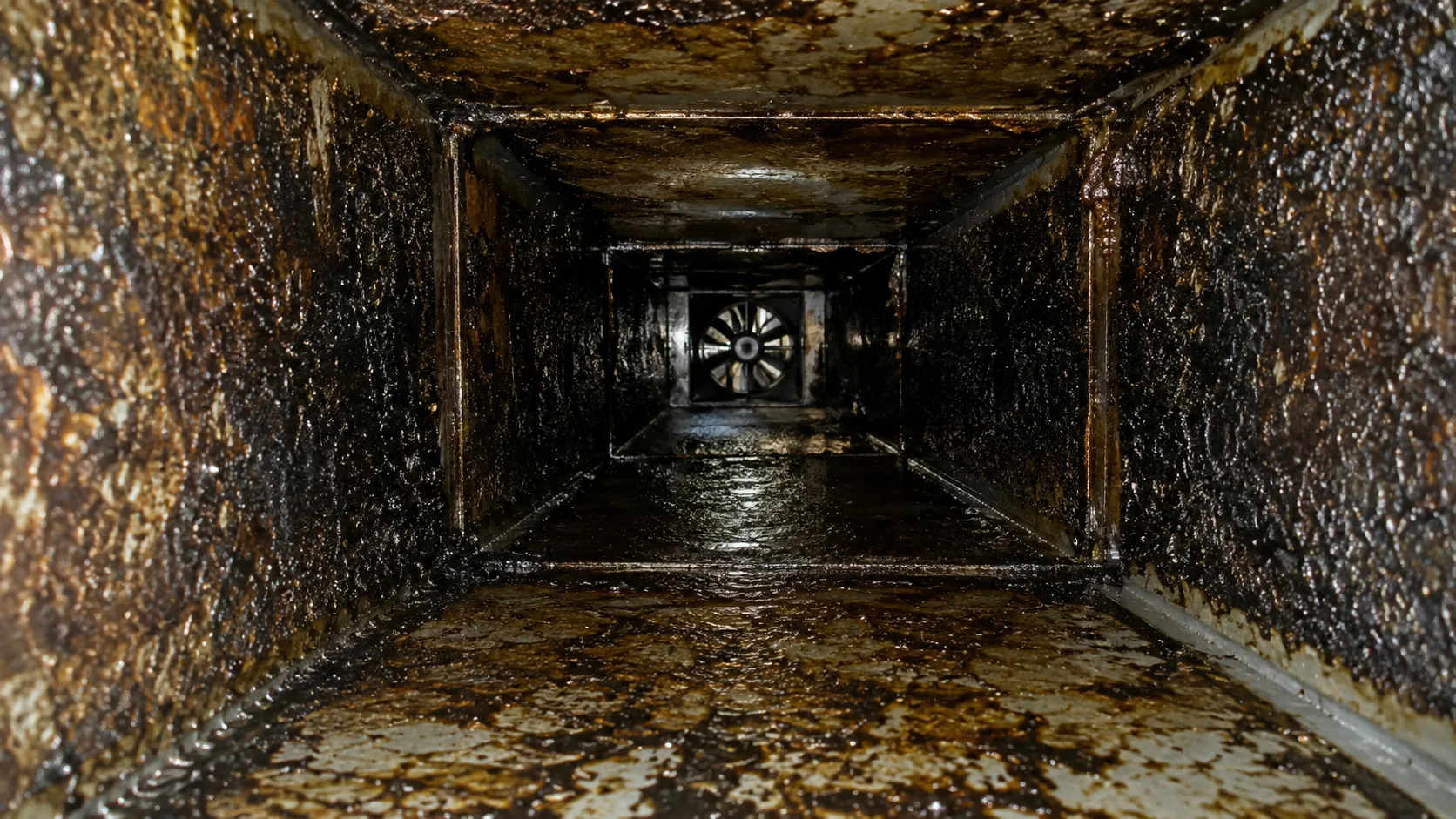 Conceptual stock-style view of grease accumulation inside commercial exhaust ductwork